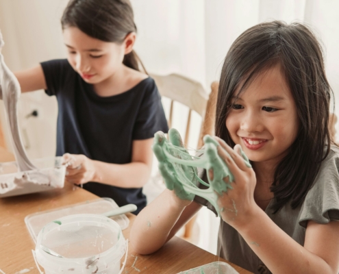 mixed Asian girl friends making slime, sensory craft, fun homeschool chemistry project